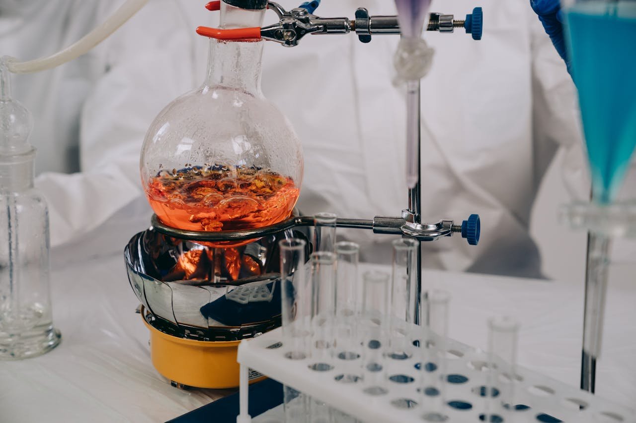 A close-up view of chemistry lab equipment with flasks and vials during an experiment.